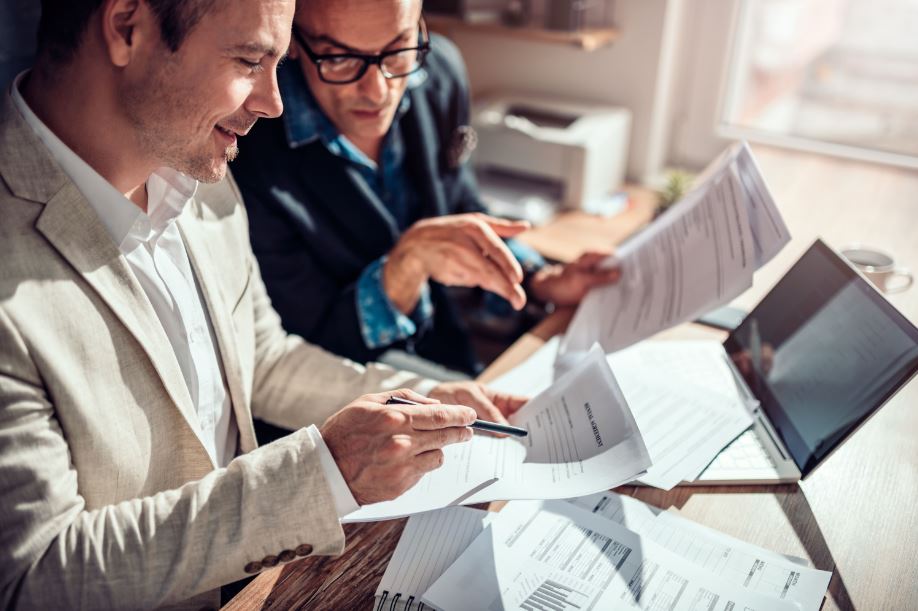a lawyer and an investor looking at legal real estate documents
