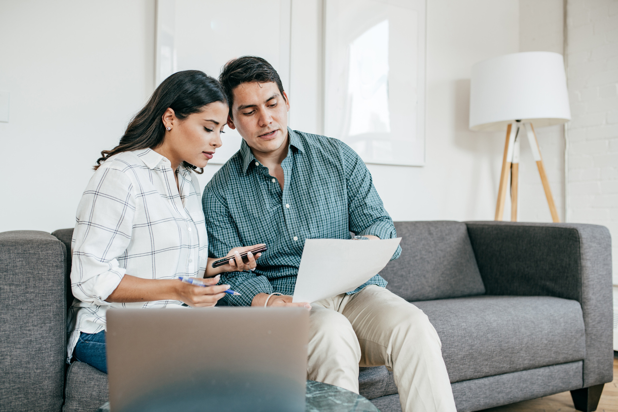 Couple looking at their moving insurance policies before a DIY move