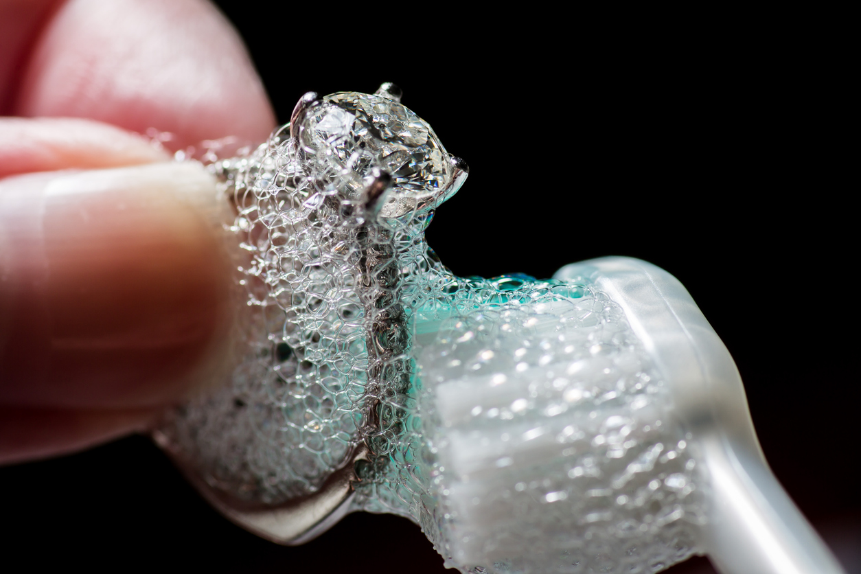 Cleaning a ring with a toothbrush and soap solution