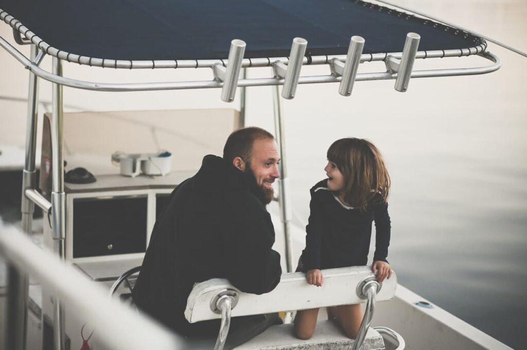 Father and daughter on a fishing boat